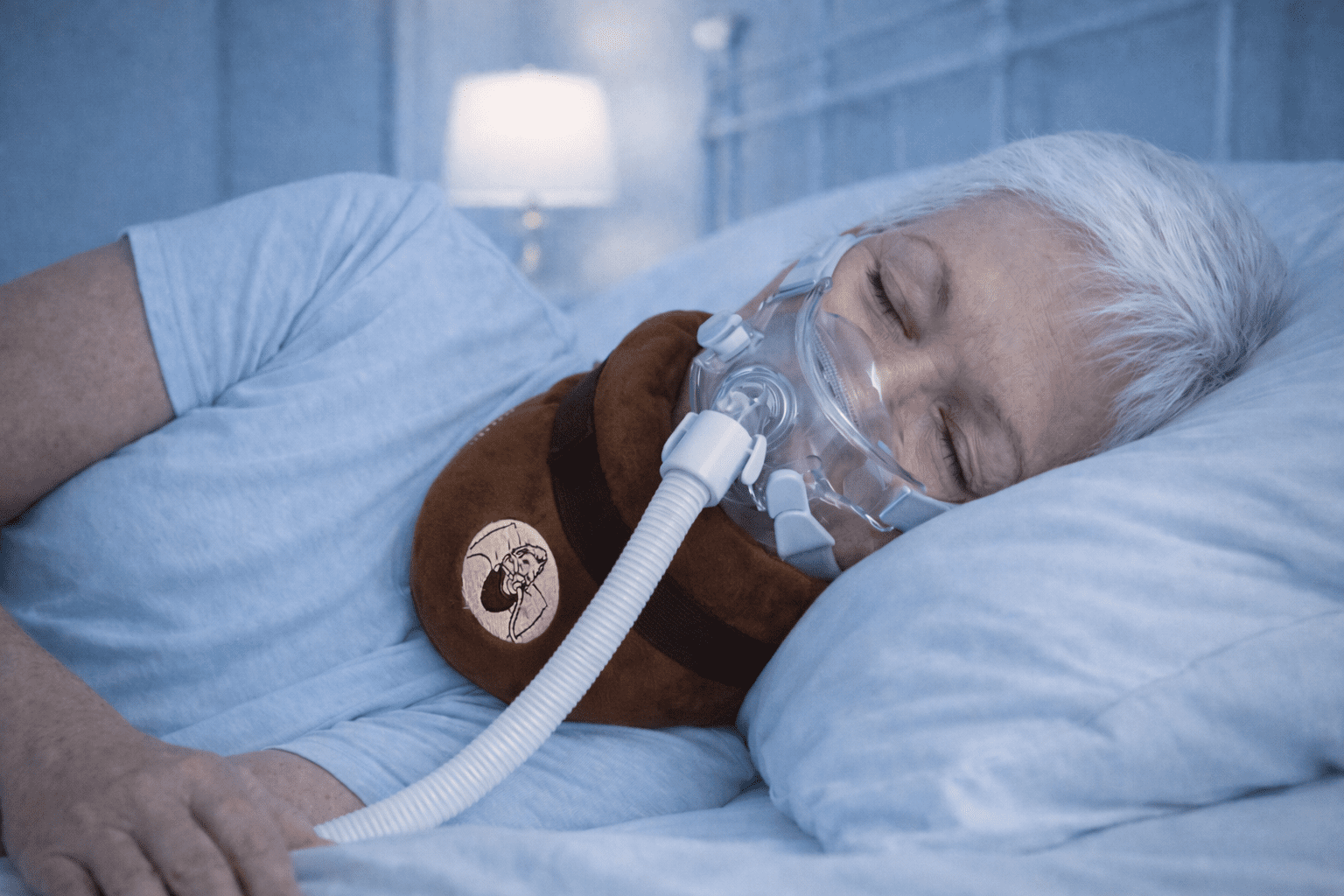 Man sleeping on his side with CPAP mask using neck support cushion to maintain alignment and reduce air leaks